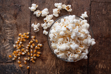 A bowl of popcorn on a wooden table