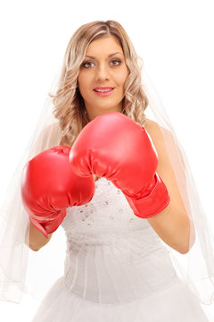 Cheerful bride with red boxing gloves