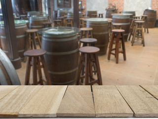 wood table top on blur background of emtry pub