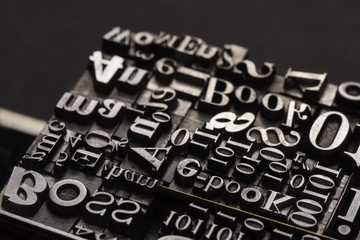 Metal Letterpress Types.
A background from many historic typographical letters in black and white with white background.