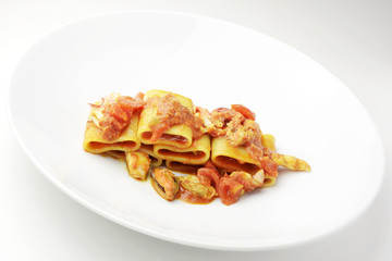 Dish of Paccheri pasta with seafood chowder sauce