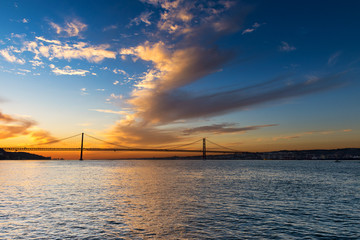 View of the bridge over the Tagus River in Lisbon, Portugal, at sunset