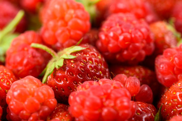 Raspberry And Strawberry Pile In Fruit Market