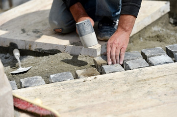 Mason working with cobblestone