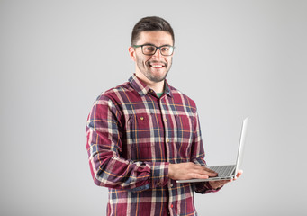 Bearded man holding laptop