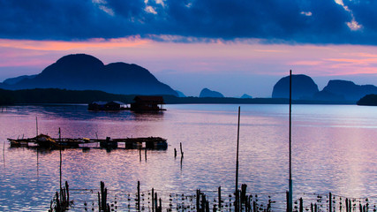 Colorful twilight in morning over seascape at fisherman village,