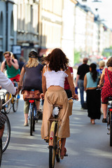 Well dressed woman on old bike, in traffic