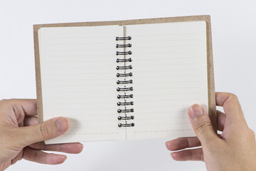 A man's hand hold the blank notebook