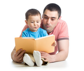 kid boy and father read a book on floor at home