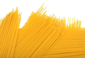 Uncooked Italian pasta spaghetti on a white