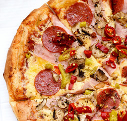 Italian pepperoni pizza with ham, red peppers and cheese