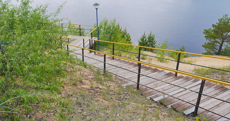 Wood and steel stairs down to river