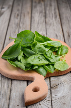 Fresh spinach leaves on wooden background, selective focus, copy space