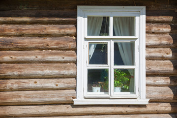 Window on old wooden facade of Russian town