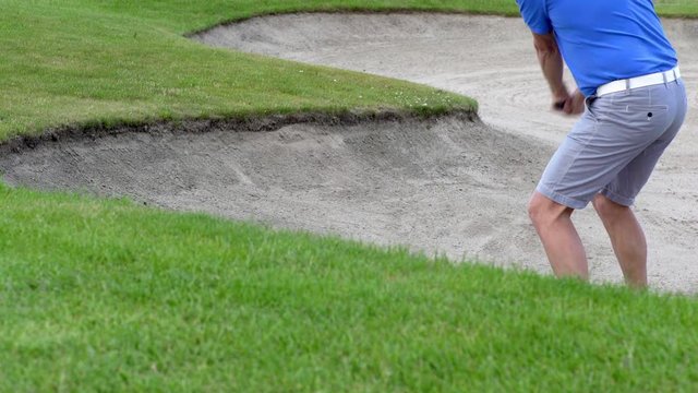 A golfer hitting a bunker shot