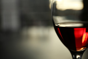 Glass of red wine on blurred background
