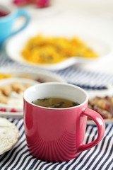 Cup of tea with aromatic dry tea on wooden background