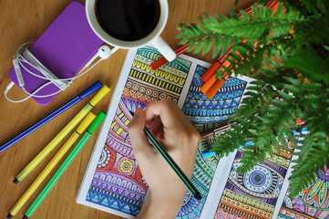 Coloring an adult coloring book
