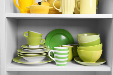 Tableware on shelves in the kitchen cupboard