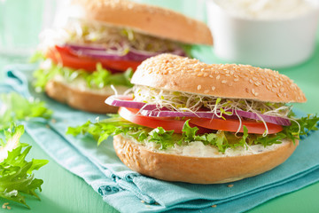 tomato sandwich on bagel with cream cheese onion lettuce alfalfa