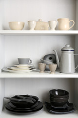 Tableware on shelves in the kitchen cupboard
