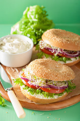 tomato sandwich on bagel with cream cheese onion lettuce alfalfa