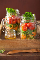 Fototapeta na wymiar healthy vegetable salad in mason jar. tomato, broccoli, carrot,