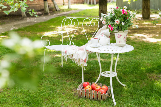 Summer garden with tea party setting. Outdoor decorations.