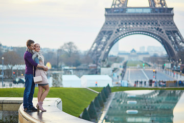 Romantic couple near the Eiffel tower in Paris, France