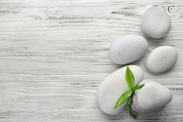 Heap of spa hot stones on white wooden background