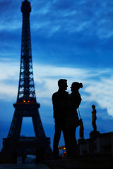 Silhouettes of romantic couple near the Eiffel tower