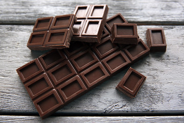 Chocolate pieces on wooden background