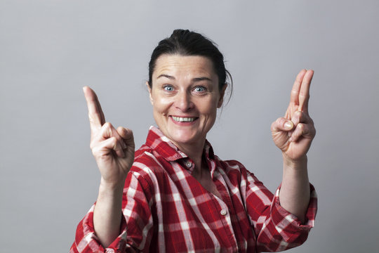 thrilled woman showing both hands like fun guns for power