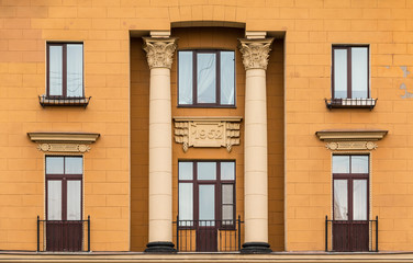 Several windows in a row and balconies on facade of urban apartment building front view, St. Petersburg, Russia.