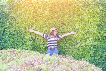 Cheerful happy hipster girl in the garden morning in sunlight,Smiling girl in the garden
