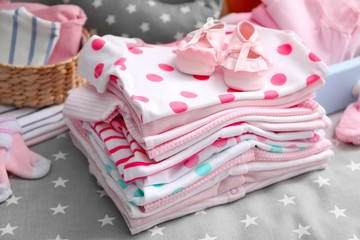 Baby clothes for newborn on grey blanket