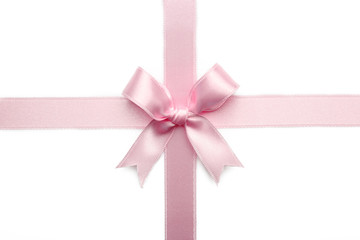 Pink ribbon bow on white background