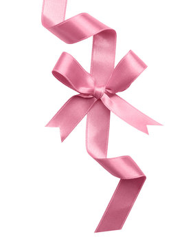 Pink ribbon with bow on white background