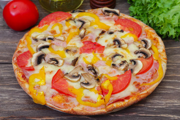 Homemade Hot Supreme PIzza with mushrooms, peppers, ham, tomato and cheese