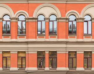 Obraz premium Several windows in a row on facade of urban apartment building front view, St. Petersburg, Russia.