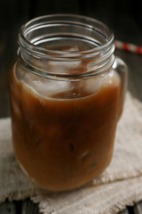 Jar of iced coffee on wooden table