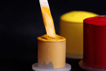 Tattoo needle with yellow and red ink