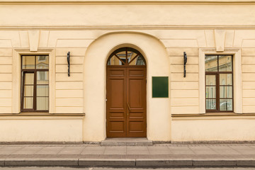 Fototapeta na wymiar Door and windows on facade of urban office building front view, St. Petersburg, Russia.