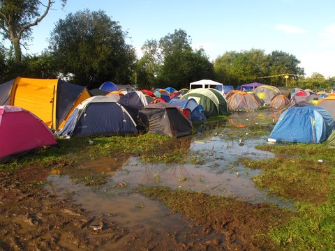summer music festival flooded campsite muddy tents in England, UK
