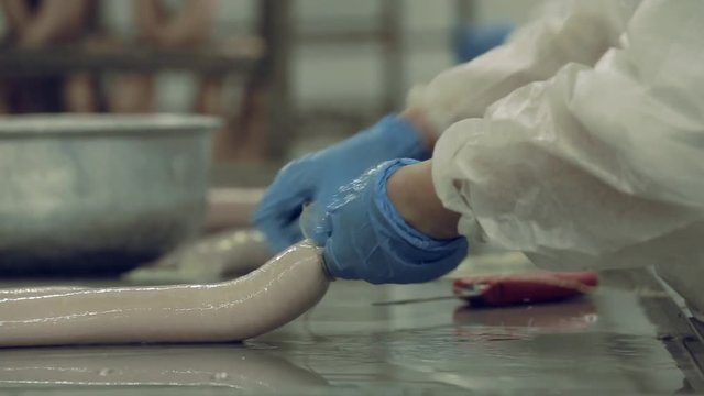 Industrial production of sausages. Production and packing of salami and bologna sausage in the meat industry. 