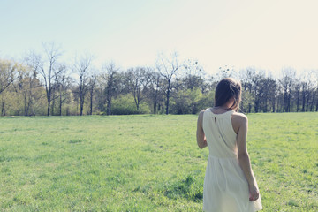 girl walking through a meadow