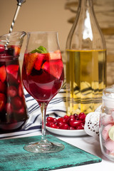 Fototapeta na wymiar Summer home wine with fruits, sangria cocktail, dogwood berries plate