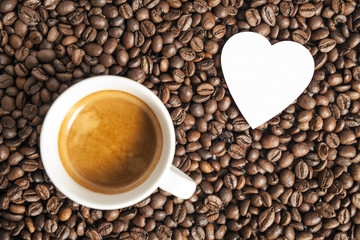 Valentine's Day and espresso. Coffee cap and heart on the beans background