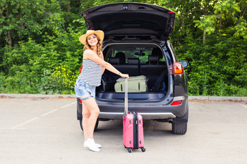 Vacation, Travel - young woman ready for the traveling. suitcases and car