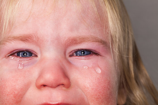 portrait of emotional tears crying baby toddler blond long hair
